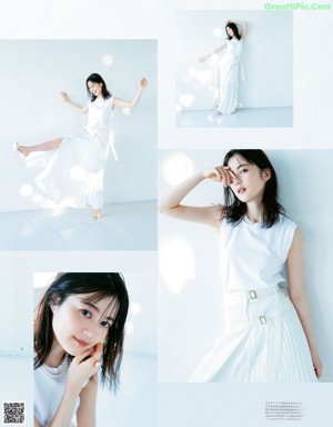 A woman in a white dress sitting on a white surface.