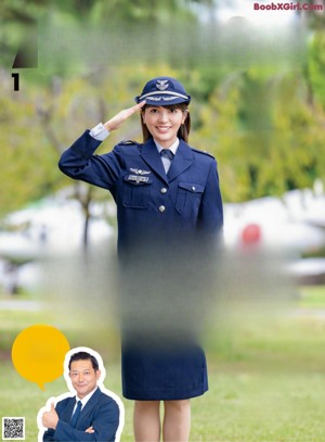 A woman in a military uniform standing in front of a line of soldiers.