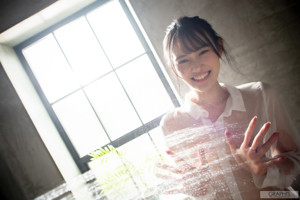 A woman in a white shirt is standing in the water.