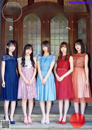 A group of three young women standing next to each other.